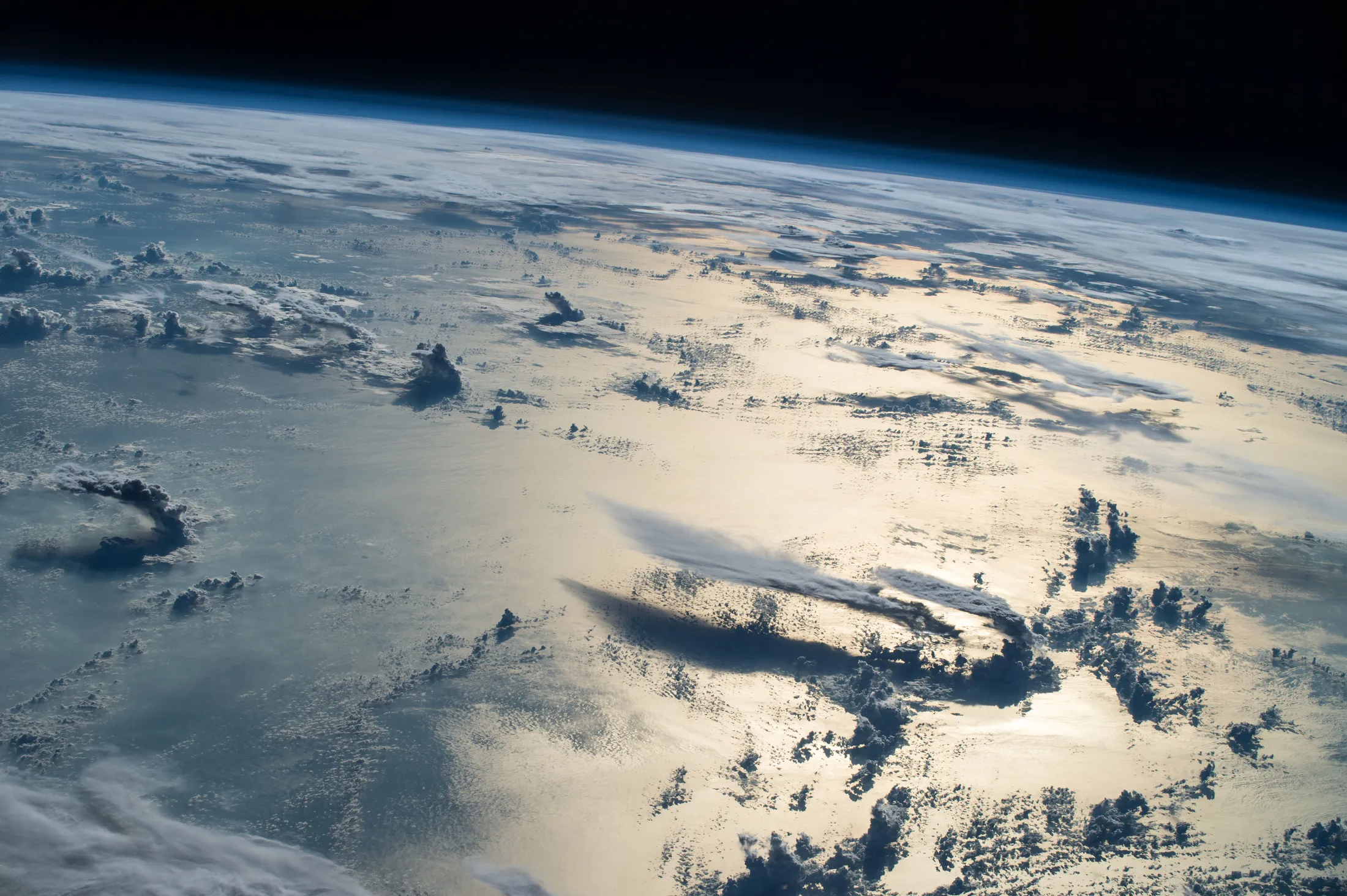 Cloud layers and Earth's blue horizon above the Philippine Sea, photographed from the International Space Station.